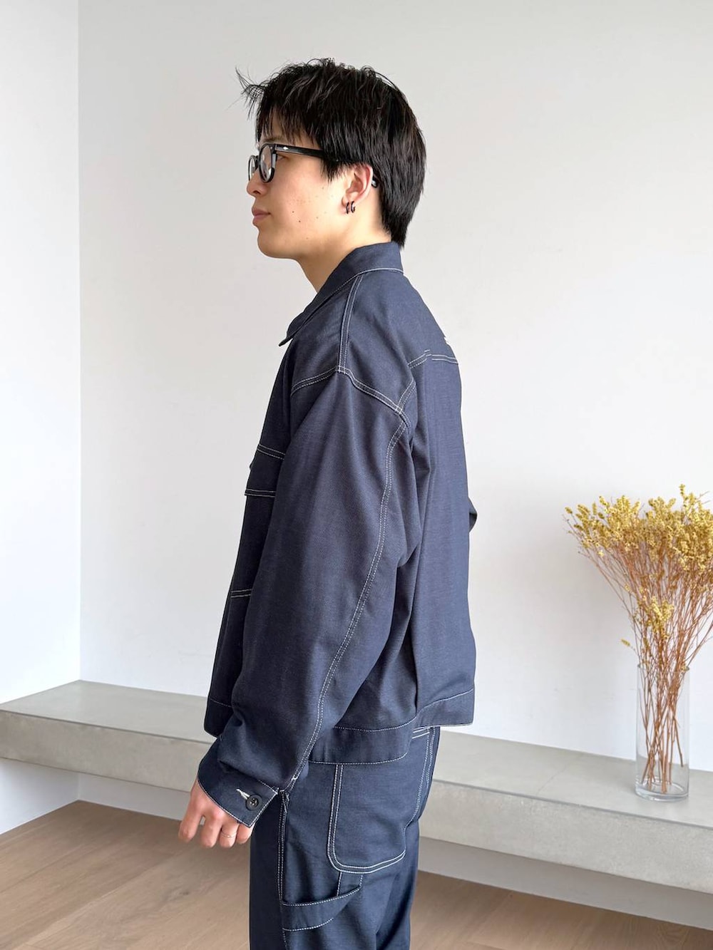 ブルー系のTシャツ/カットソー、グレー系のその他シューズ、ブルー系のデニムパンツを着用したメンズの秋コーディネートの6枚目の写真