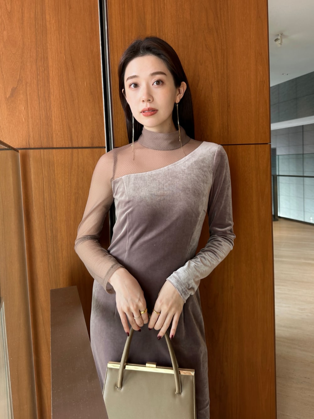 ベージュ系のハンドバッグ、ブラック系のブーツ、ベージュ系のワンピースを着用したレディースの冬コーディネートの3枚目の写真