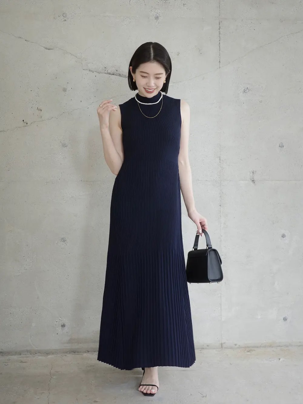 ブルー系のワンピースを着用したレディースの春コーディネートの2枚目の写真