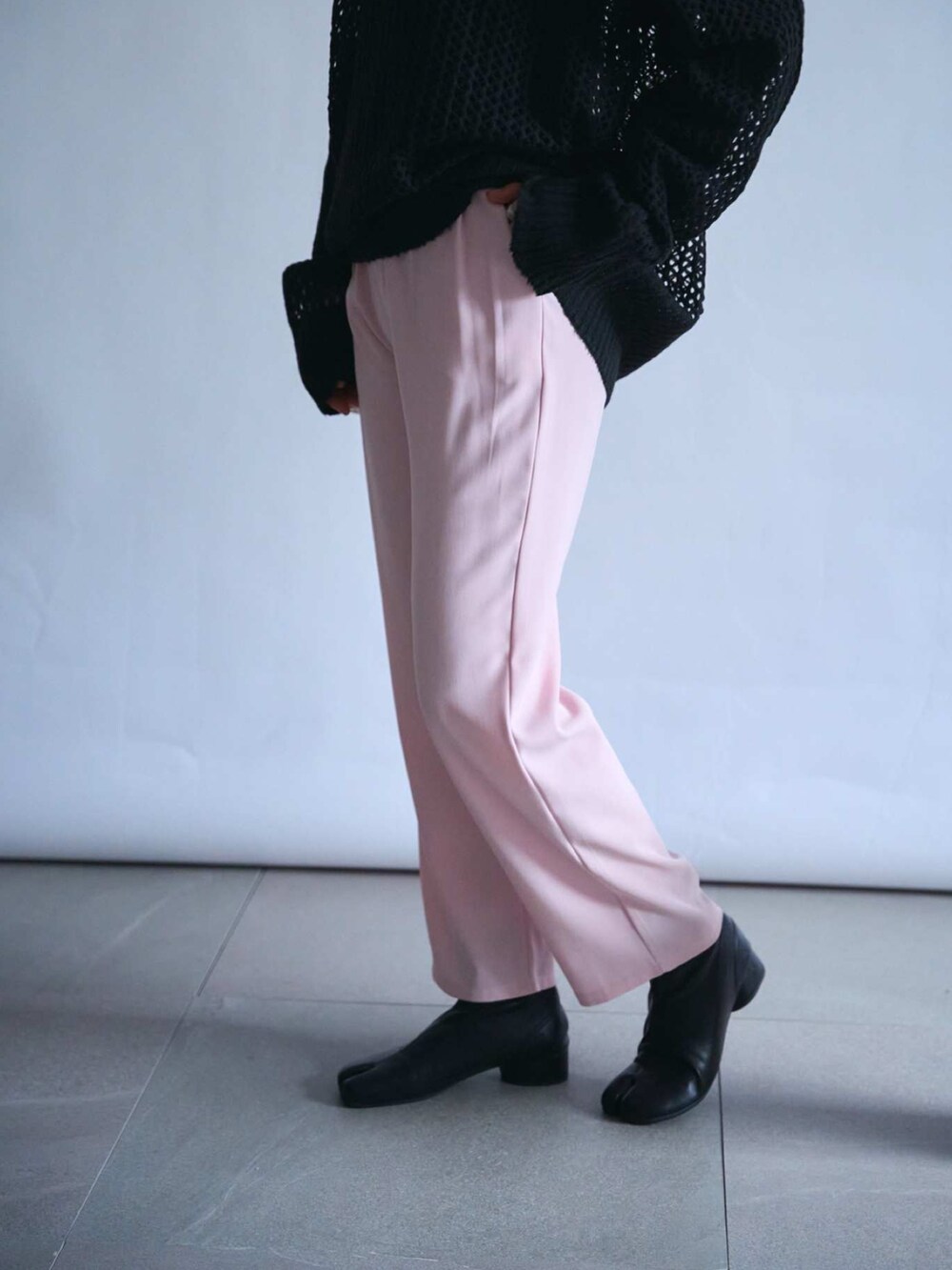 ブラック系のニット/セーター、ピンク系のその他パンツ、その他のマフラーを着用したレディースの秋コーディネートの3枚目の写真