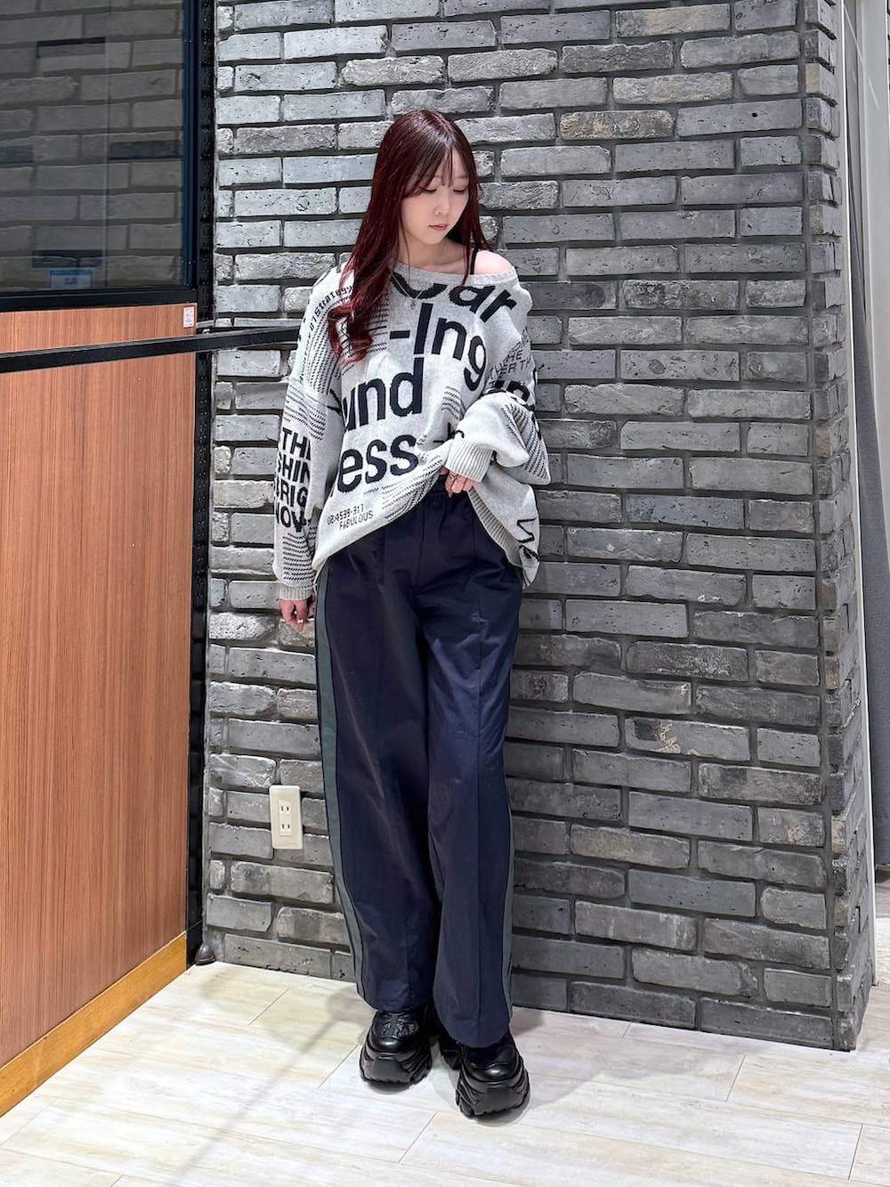 ブラック系のスニーカー、ブルー系のスウェットパンツ、グレー系のニット/セーターを着用したレディースの冬コーディネートの3枚目の写真