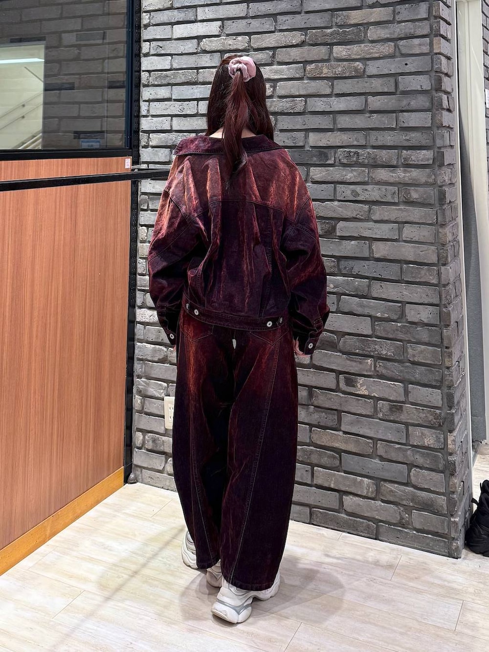 レッド系のデニムパンツ、レッド系のデニムジャケットを着用したレディースの秋コーディネートの4枚目の写真