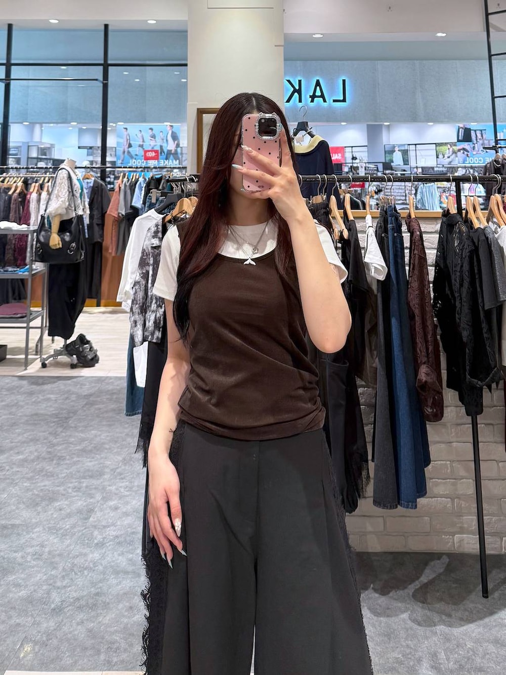 ブラウン系のタンクトップ、ホワイト系のTシャツ/カットソー、ブラック系のスラックスを着用したレディースの夏コーディネートの2枚目の写真