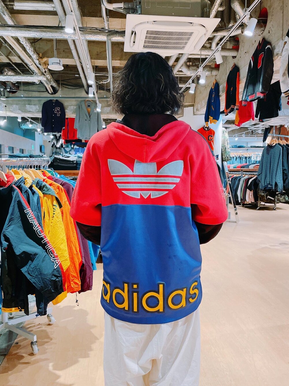 レッド系のトップス、ホワイト系のその他パンツ、イエロー系のスニーカーを着用したメンズの春コーディネートの2枚目の写真