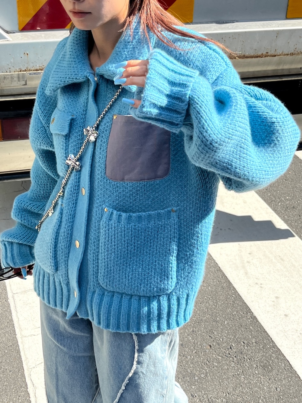 ブルー系のニット/セーター、ブラック系のハンチング/ベレー帽を着用したレディースの秋コーディネートの2枚目の写真