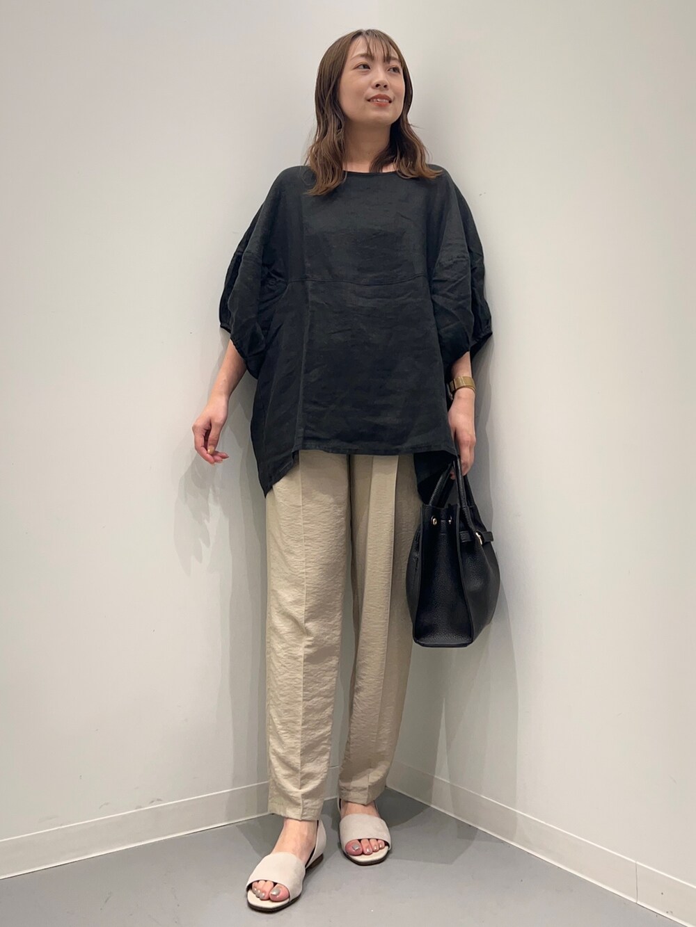 ブラック系のシャツ/ブラウス、ベージュ系のその他パンツ、ホワイト系のサンダルを着用したレディースの夏コーディネートの2枚目の写真