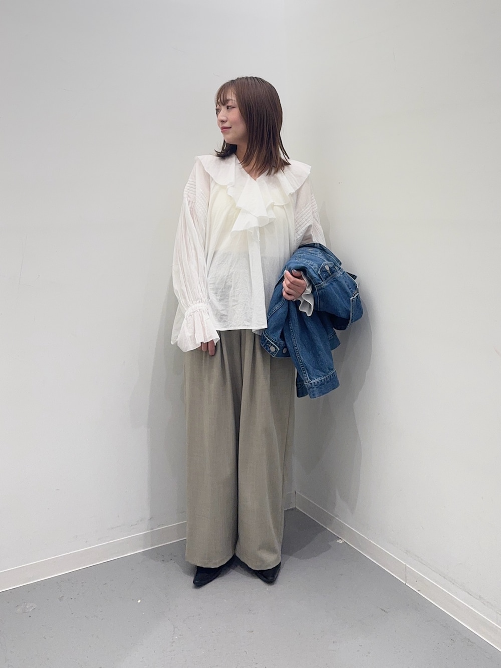 ブルー系のデニムジャケット、ホワイト系のシャツ/ブラウス、ベージュ系のその他パンツを着用したレディースの春コーディネートの5枚目の写真