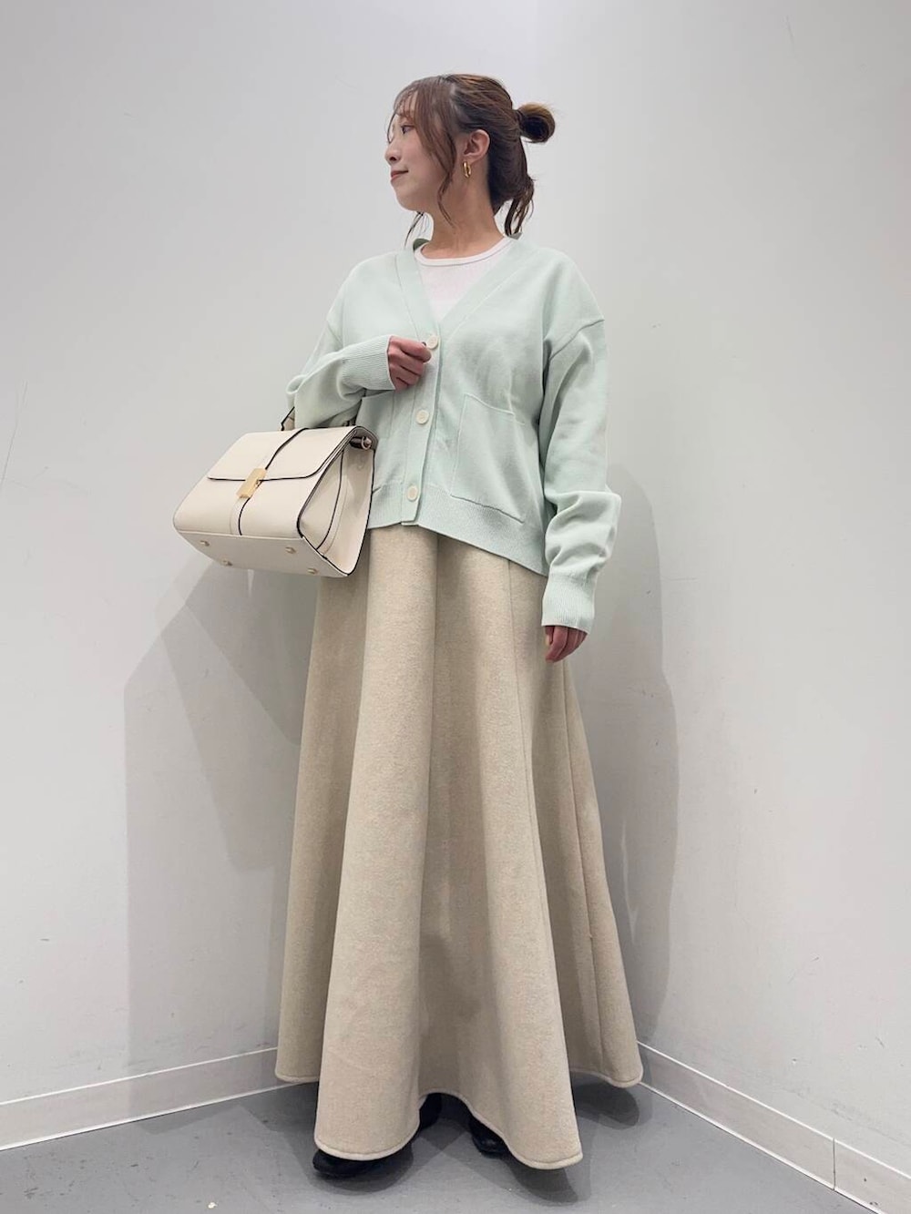 ブラック系のローファー、ホワイト系のTシャツ/カットソー、ホワイト系のハンドバッグを着用したレディースの冬コーディネートの2枚目の写真