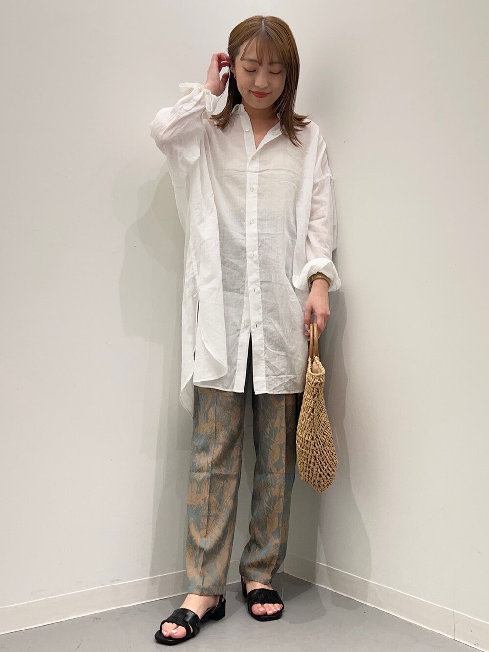 ホワイト系のシャツ/ブラウス、グレー系のその他パンツ、ブラック系のパンプスを着用したレディースの春コーディネートの2枚目の写真