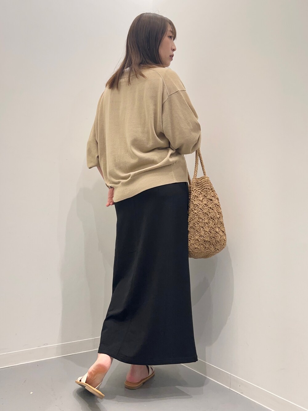 ホワイト系のTシャツ/カットソー、ベージュ系のカーディガン/ボレロ、ブラック系のスカートを着用したレディースの夏コーディネートの4枚目の写真