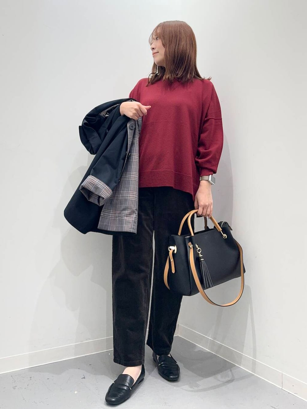 ブラック系のローファー、ブラック系のトートバッグ、ブルー系のステンカラーコートを着用したレディースの秋コーディネートの5枚目の写真