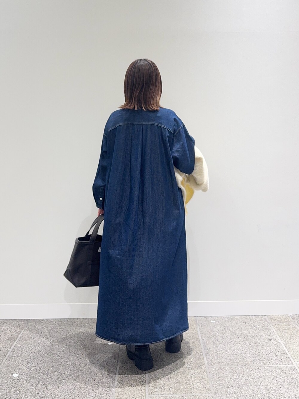 ブルー系のワンピース、ホワイト系のカーディガン/ボレロ、グレー系のトートバッグを着用したレディースの秋コーディネートの7枚目の写真