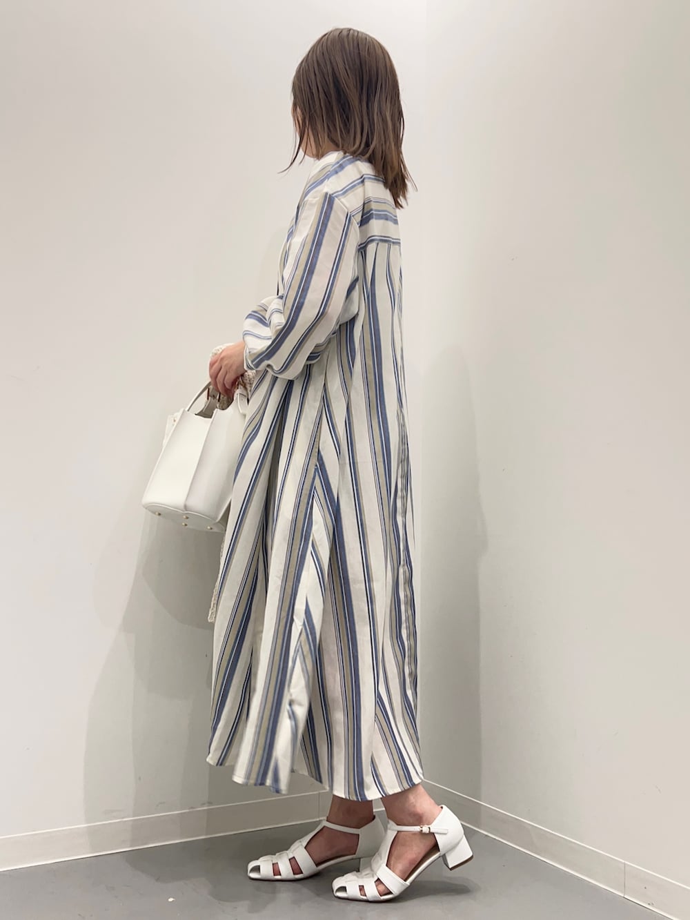 ホワイト系のカーディガン/ボレロ、ホワイト系のサンダル、ブルー系のワンピースを着用したレディースの春コーディネートの8枚目の写真