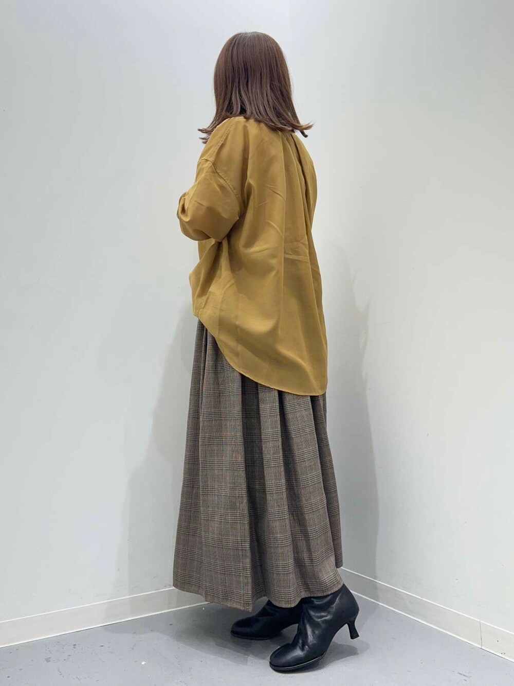 ブラック系のショルダーバッグ、イエロー系のシャツ/ブラウス、その他のスカートを着用したレディースの秋コーディネートの3枚目の写真