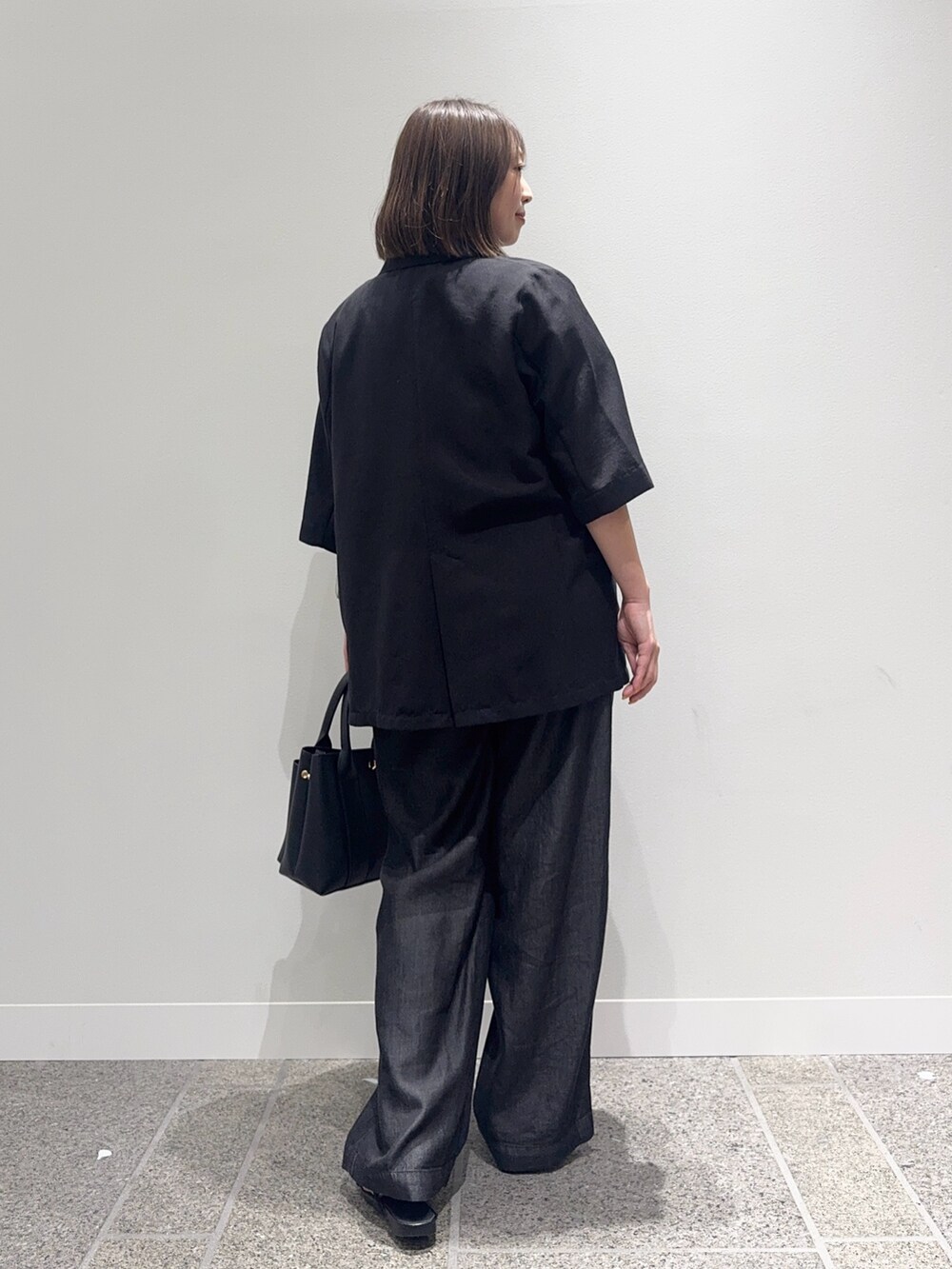 ブラック系のその他アウター、ブラック系のデニムパンツ、ブラック系のトートバッグを着用したレディースの夏コーディネートの3枚目の写真