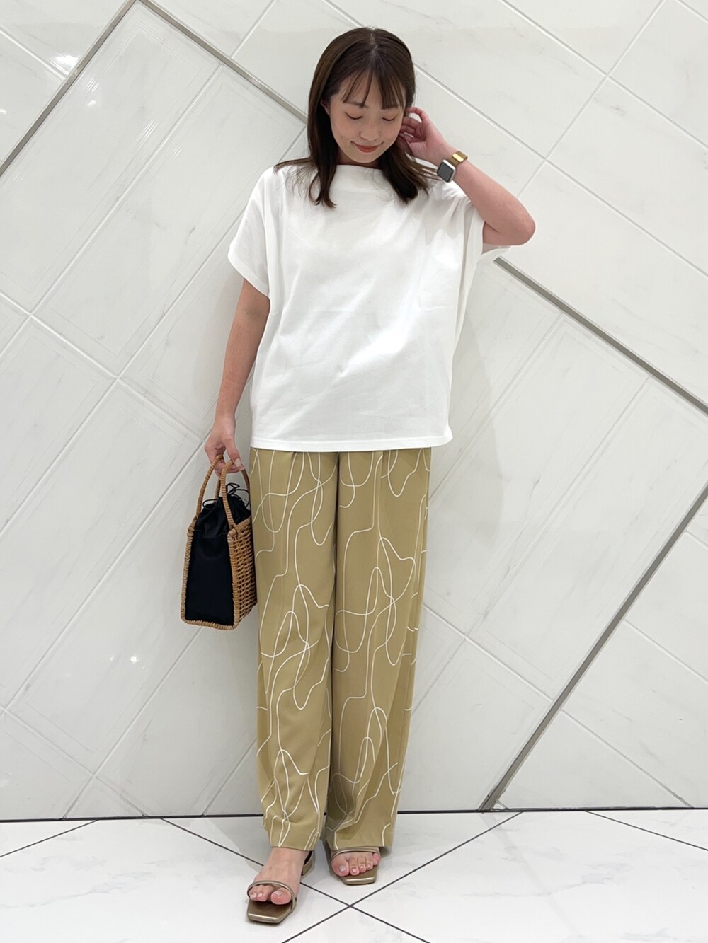 ホワイト系のTシャツ/カットソー、ベージュ系のその他パンツ、ゴールド系のサンダルを着用したレディースの夏コーディネートの6枚目の写真