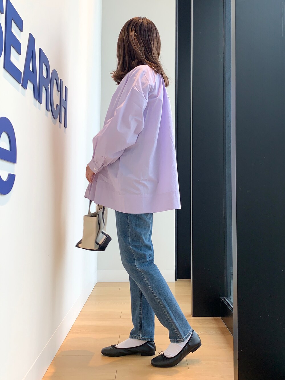 ブルー系のデニムパンツ、パープル系のシャツ/ブラウスを着用したレディースの春コーディネートの3枚目の写真