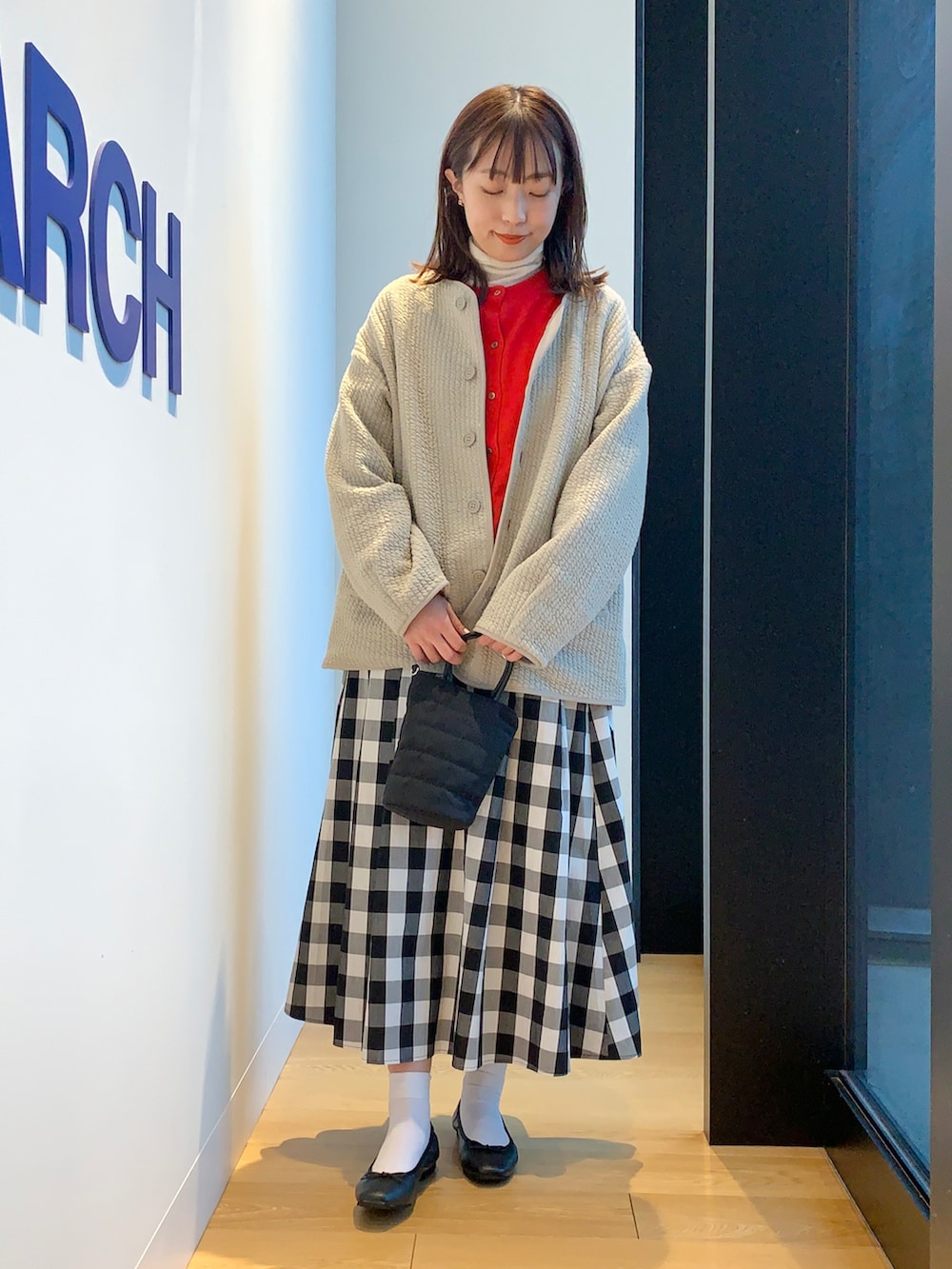 グレー系のノーカラージャケット、その他のスカート、レッド系のカーディガン/ボレロを着用したレディースの春コーディネートの2枚目の写真