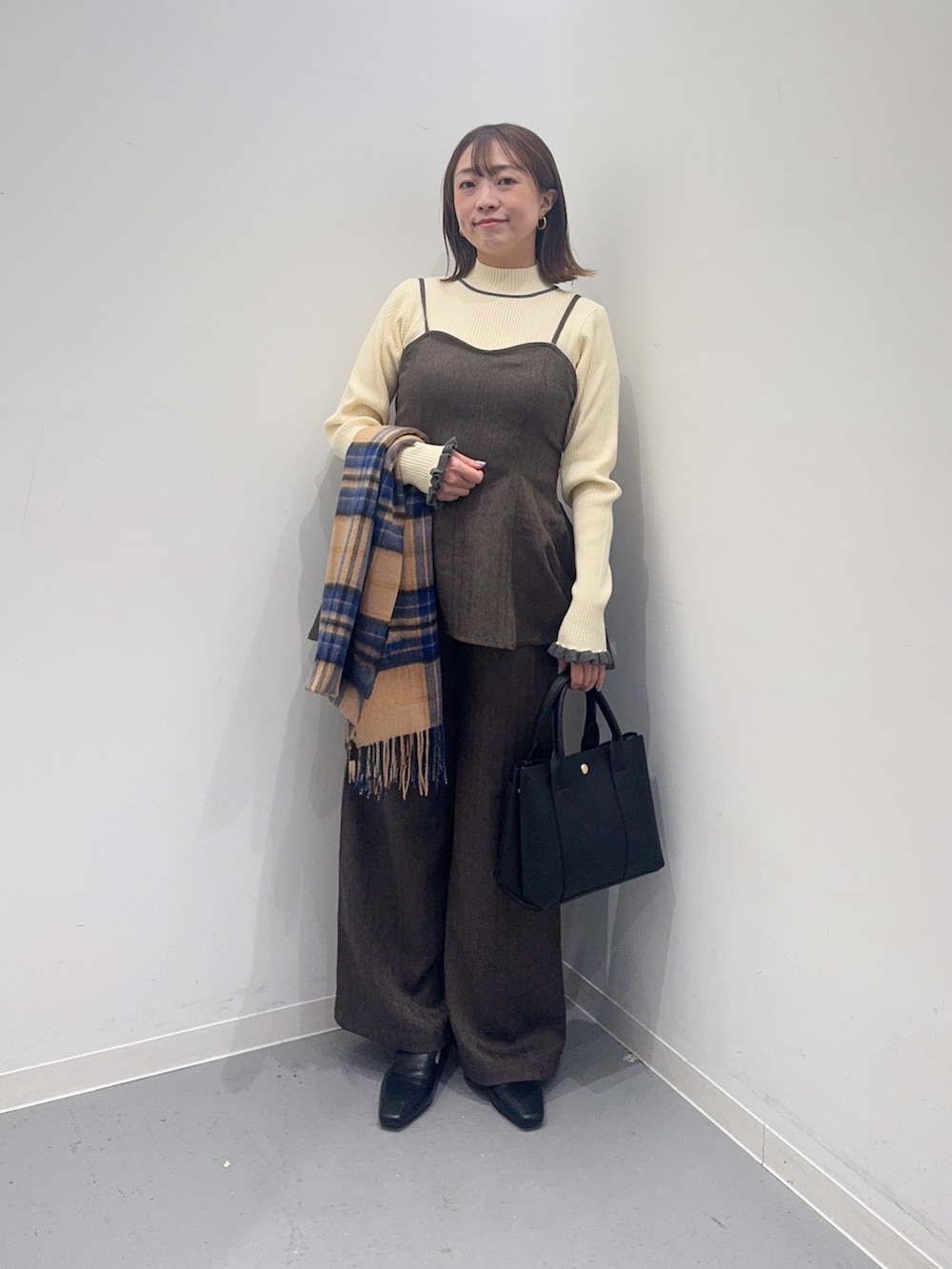 ブラウン系のサロペット/オーバーオール、ブラック系のトートバッグ、ブラック系のローファーを着用したレディースの冬コーディネートの2枚目の写真
