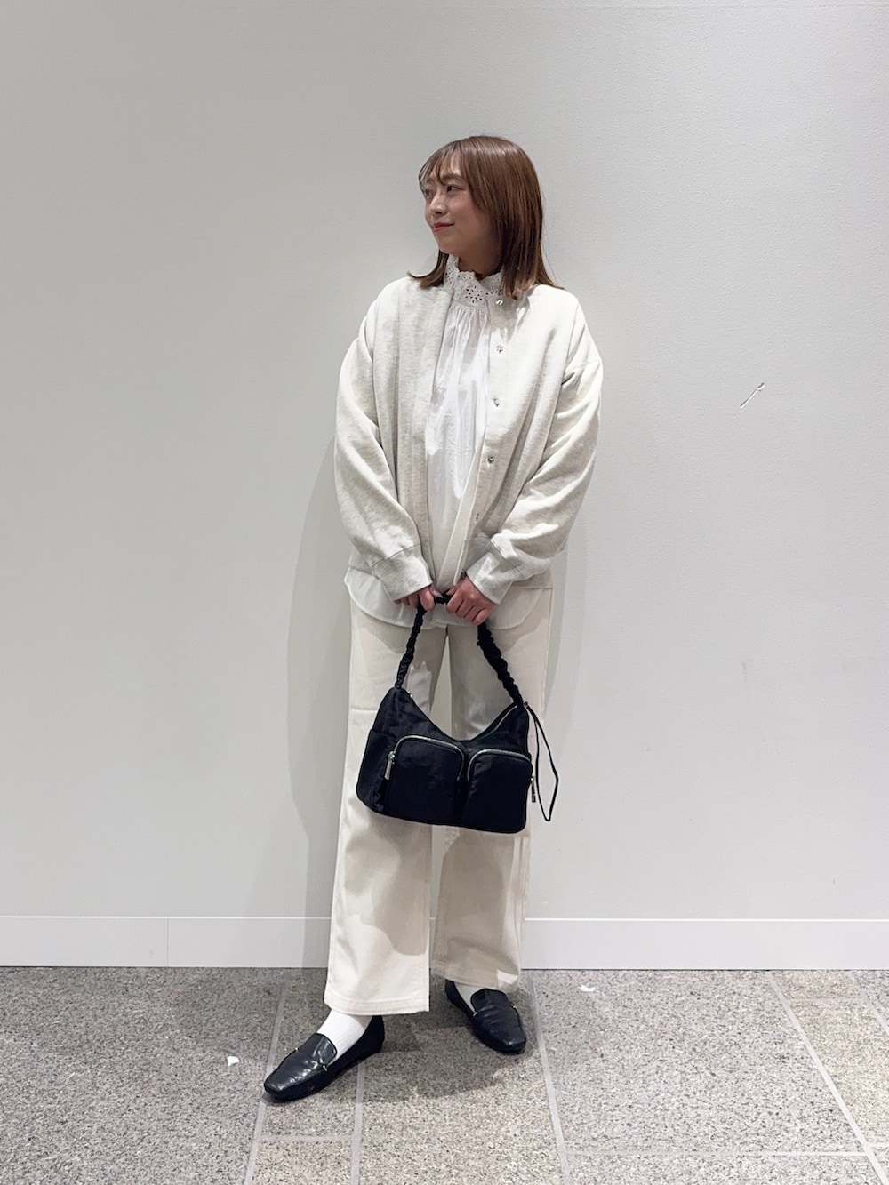 ホワイト系のシャツ/ブラウス、ベージュ系のカーディガン/ボレロ、ベージュ系のデニムパンツを着用したレディースの冬コーディネートの4枚目の写真