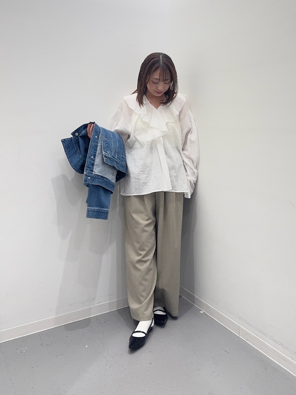 ブルー系のデニムジャケット、ホワイト系のシャツ/ブラウス、ベージュ系のその他パンツを着用したレディースの春コーディネートの6枚目の写真