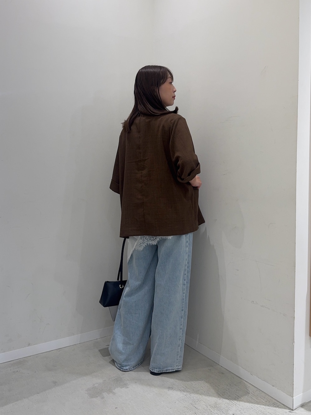 ホワイト系のタンクトップ、ブラウン系のその他アウター、ブルー系のデニムパンツを着用したレディースの夏コーディネートの4枚目の写真