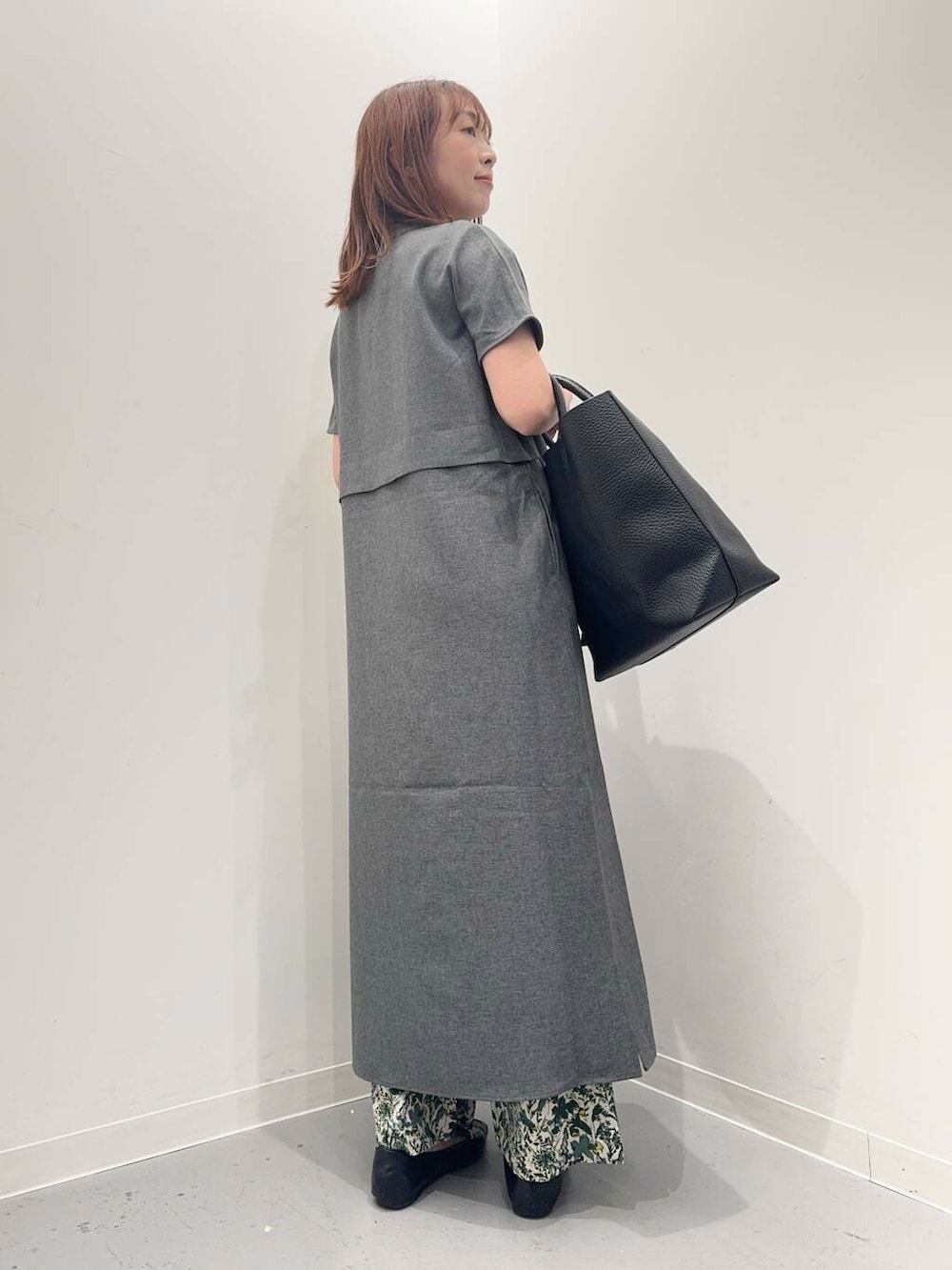 ブラック系のローファー、ブラック系のトートバッグ、グレー系のワンピースを着用したレディースの夏コーディネートの4枚目の写真
