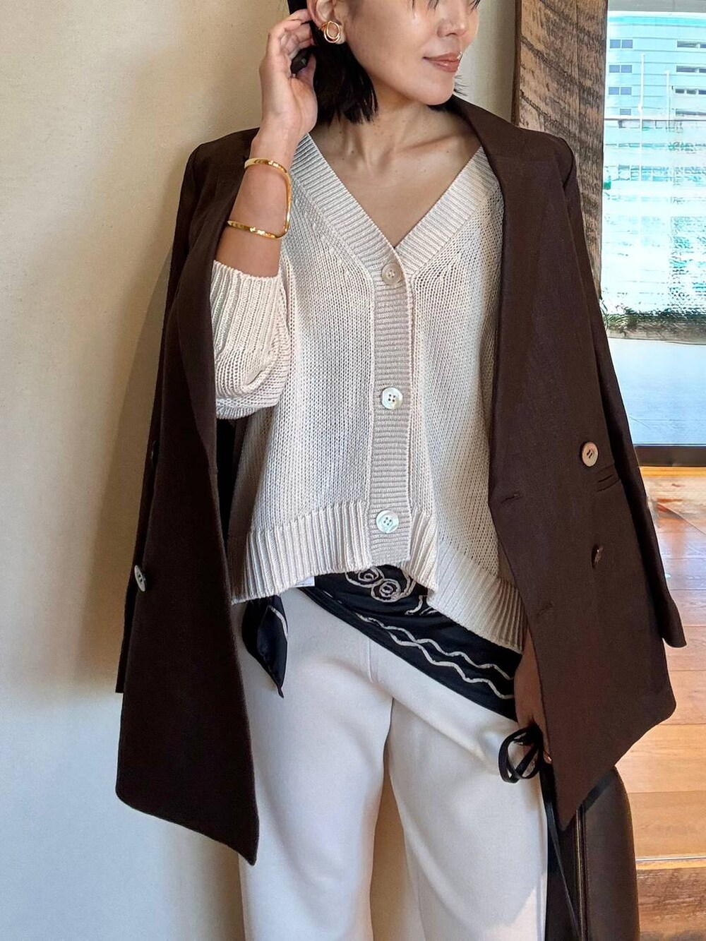 ベージュ系のその他パンツ、ブラウン系のテーラードジャケット、ベージュ系のカーディガン/ボレロを着用したレディースの冬コーディネートの4枚目の写真