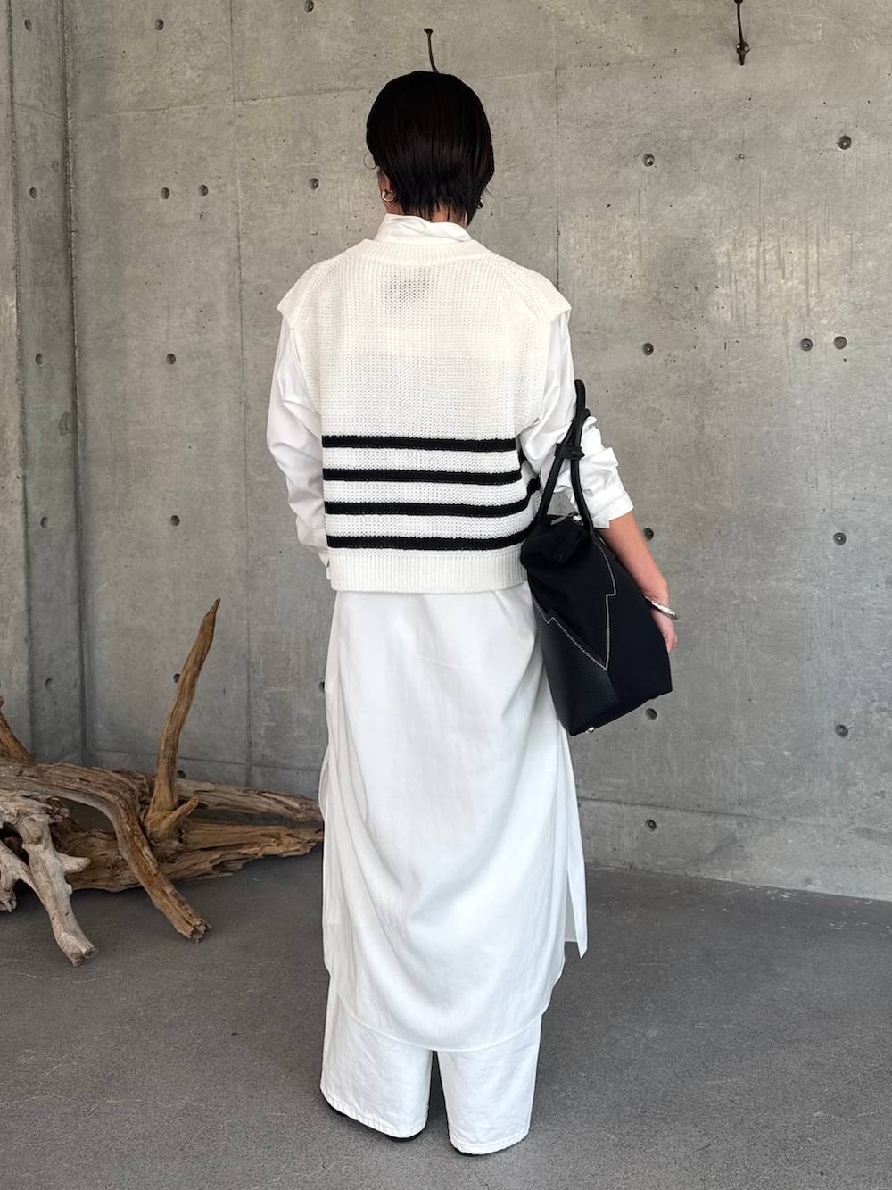 ホワイト系のデニムパンツ、ホワイト系のワンピース、その他のベストを着用したレディースの春コーディネートの4枚目の写真