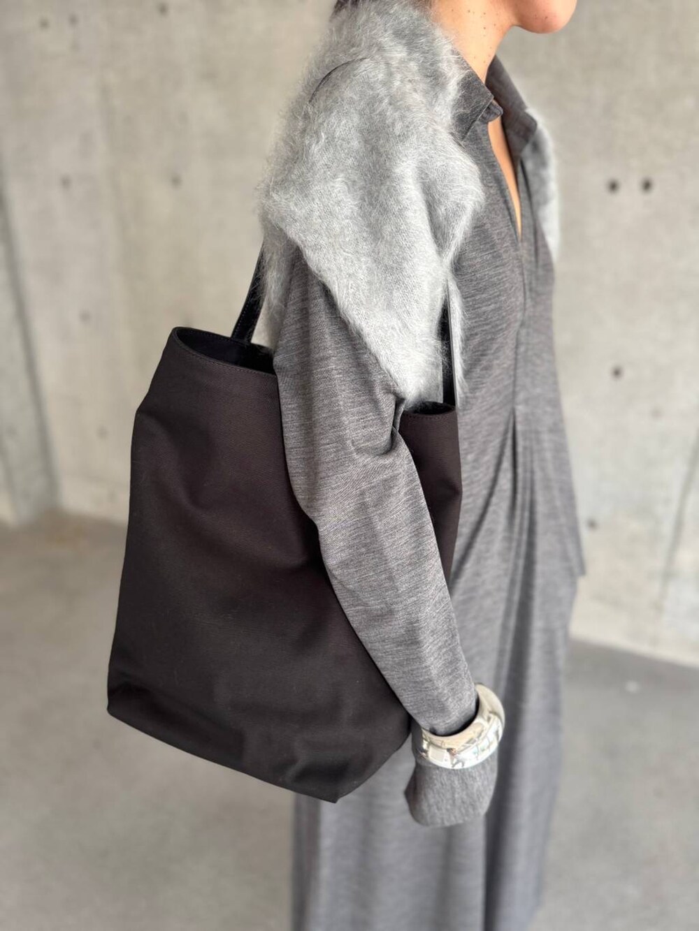 グレー系のワンピース、グレー系のニット/セーターを着用したレディースの秋コーディネートの9枚目の写真