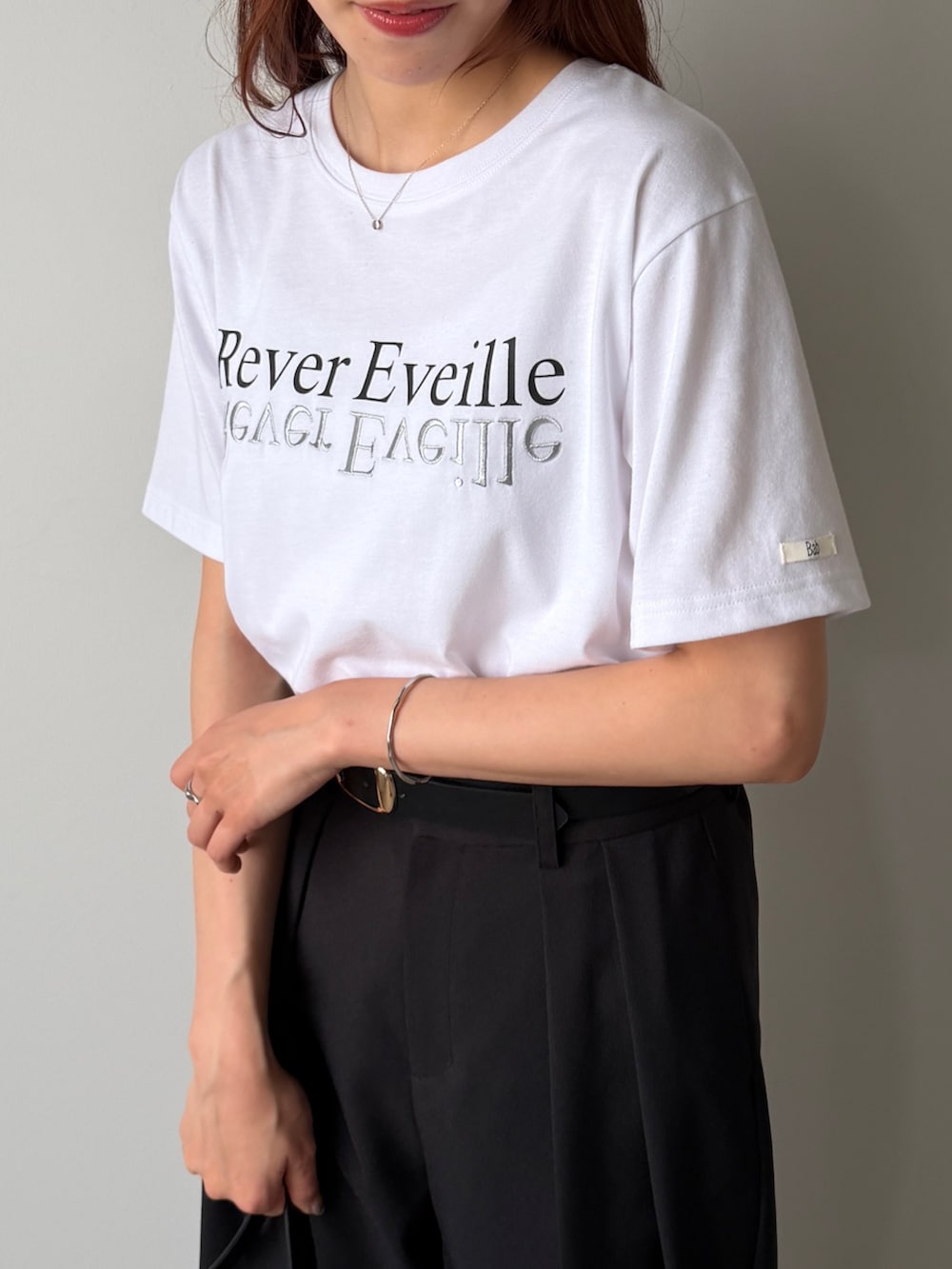 ブラック系のその他パンツ、ホワイト系のTシャツ/カットソー、ベージュ系のショルダーバッグを着用したレディースの夏コーディネートの3枚目の写真