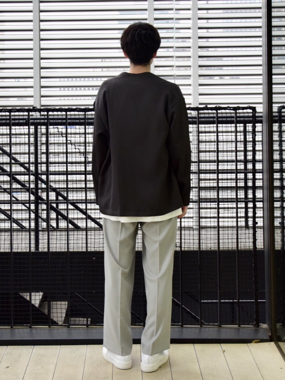 ブラウン系のカーディガン/ボレロ、ホワイト系のスラックスを着用したメンズの春コーディネートの3枚目の写真