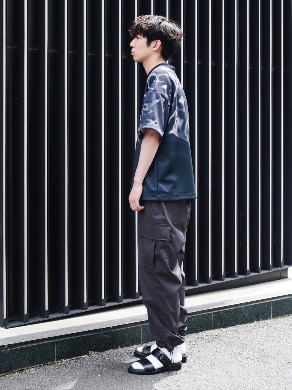 ブラック系のTシャツ/カットソー、グレー系のその他パンツを着用したメンズの夏コーディネートの2枚目の写真
