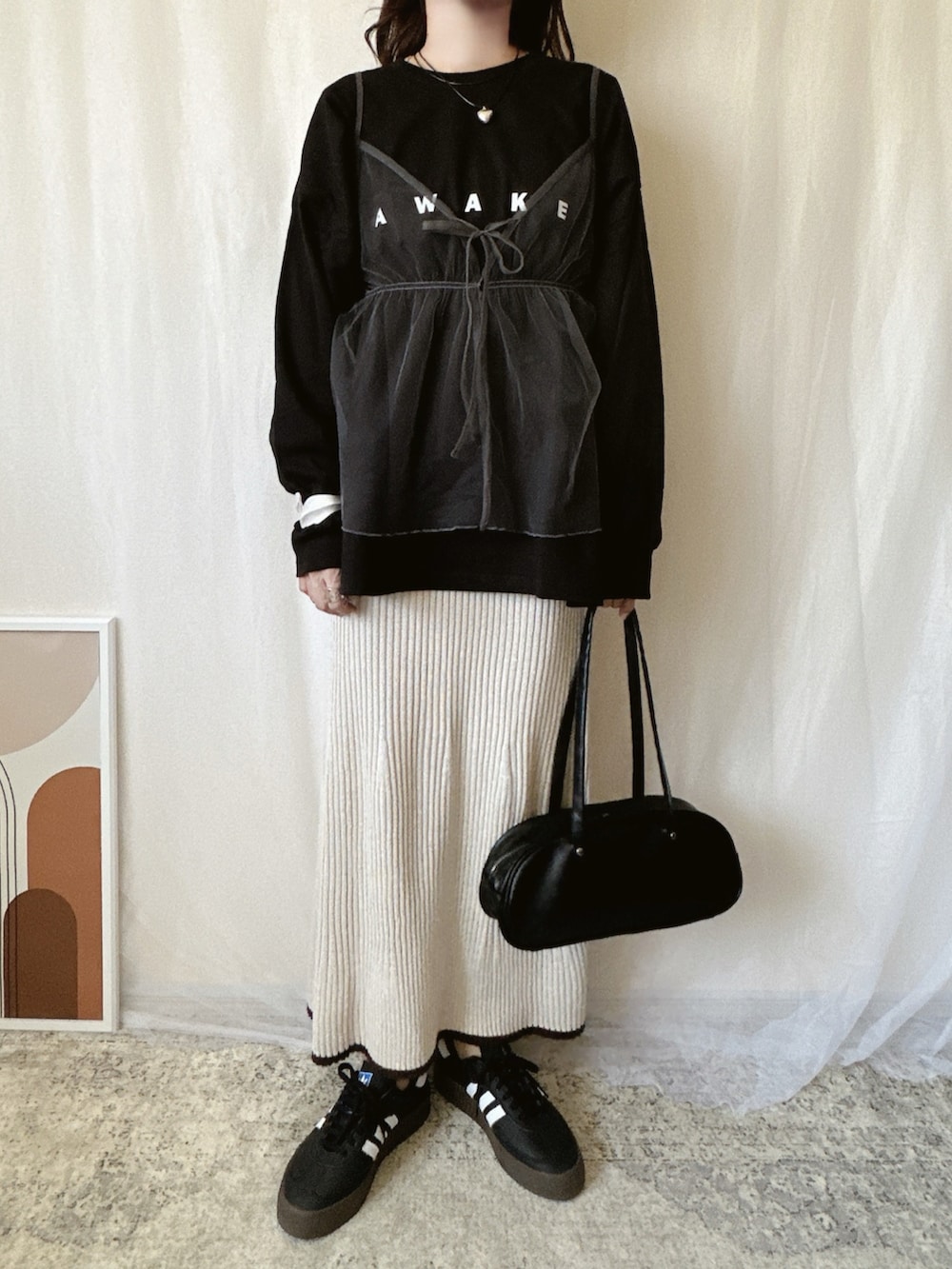 ブラック系のTシャツ/カットソーを着用したレディースの春コーディネートの3枚目の写真