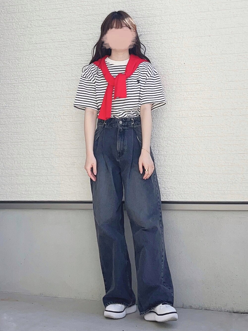 ホワイト系のTシャツ/カットソー、ブラック系のデニムパンツ、ホワイト系のスニーカーを着用したレディースの春コーディネートの2枚目の写真