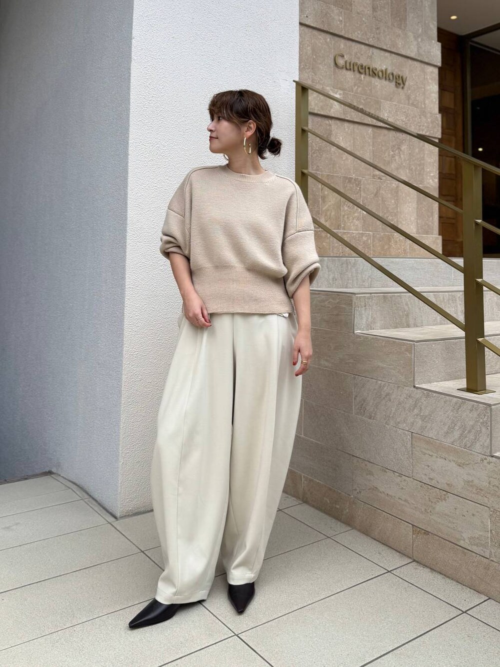 ホワイト系のTシャツ/カットソー、ホワイト系のその他パンツ、ベージュ系のニット/セーターを着用したレディースの秋コーディネートの3枚目の写真