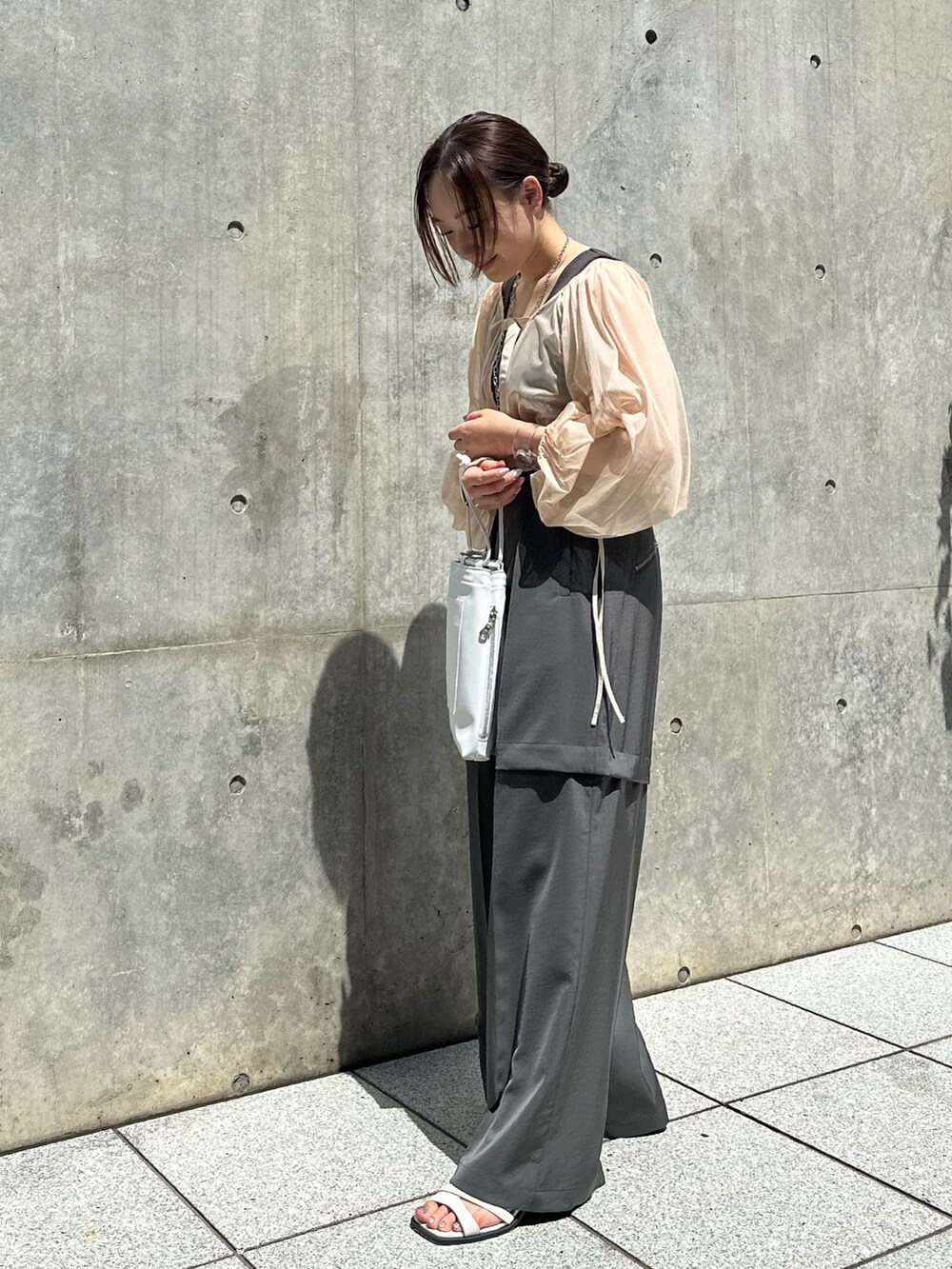 ホワイト系のシャツ/ブラウス、グレー系のその他パンツ、ホワイト系のショルダーバッグを着用したレディースの夏コーディネートの2枚目の写真