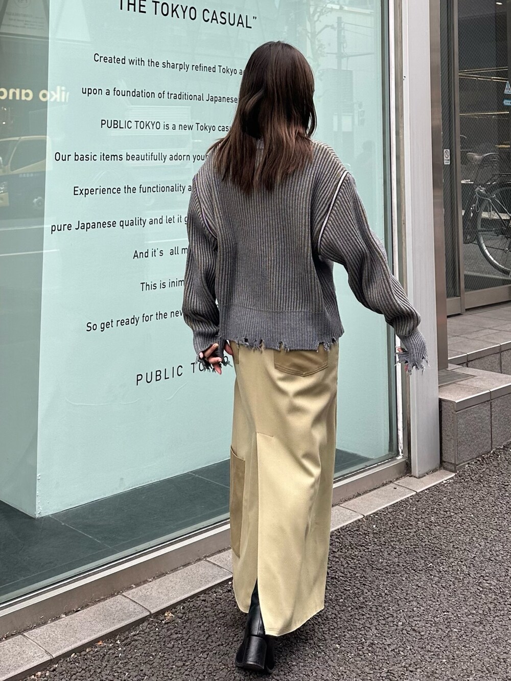 ベージュ系のスカート、グレー系のニット/セーターを着用したレディースの冬コーディネートの4枚目の写真