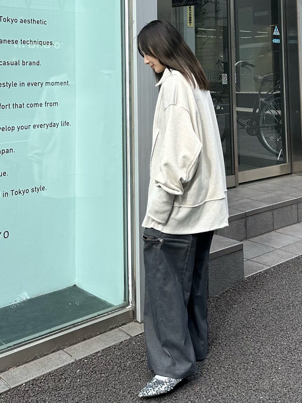 ベージュ系のスウェット、グレー系のスラックスを着用したレディースの秋コーディネートの3枚目の写真