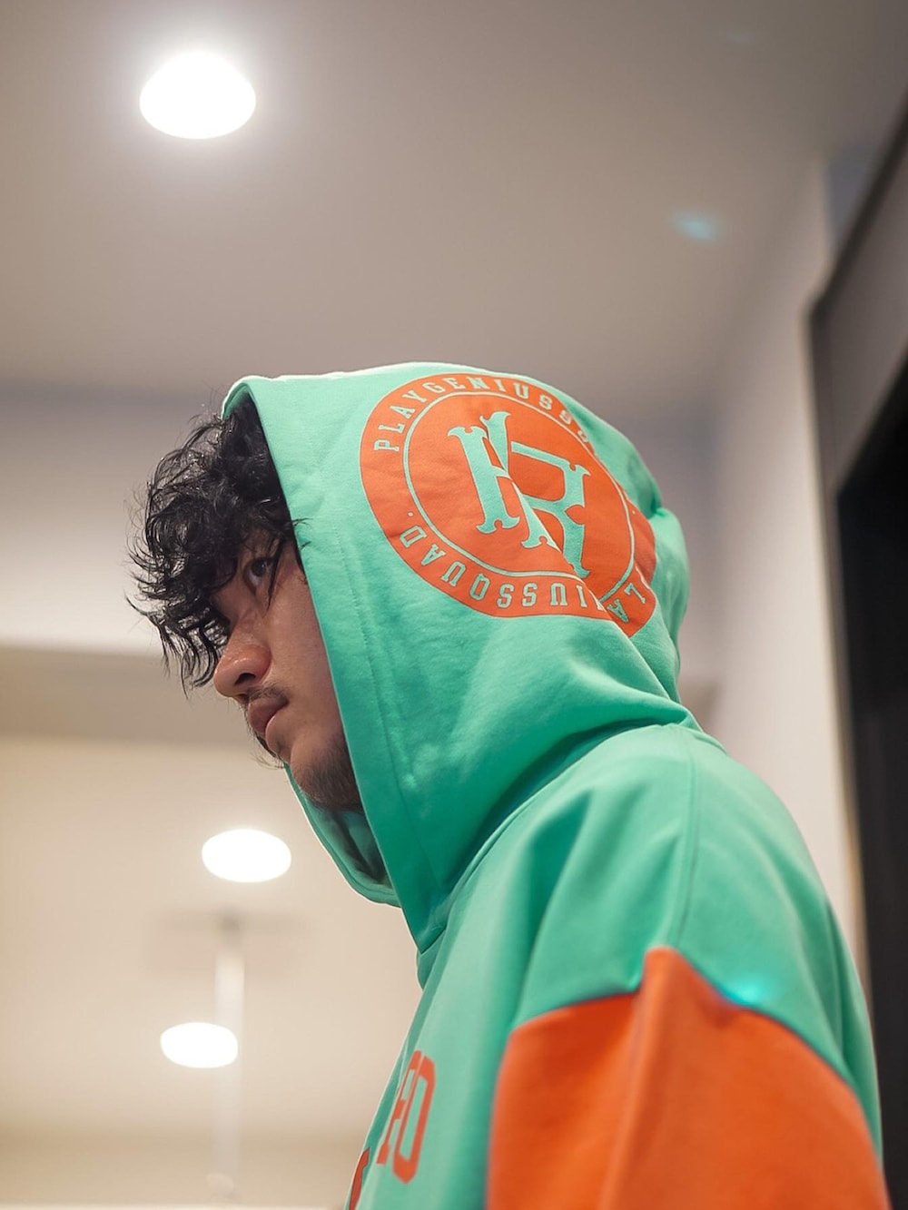 グリーン系のパーカー、グリーン系のスウェットパンツ、グレー系のスニーカーを着用したメンズの冬コーディネートの2枚目の写真