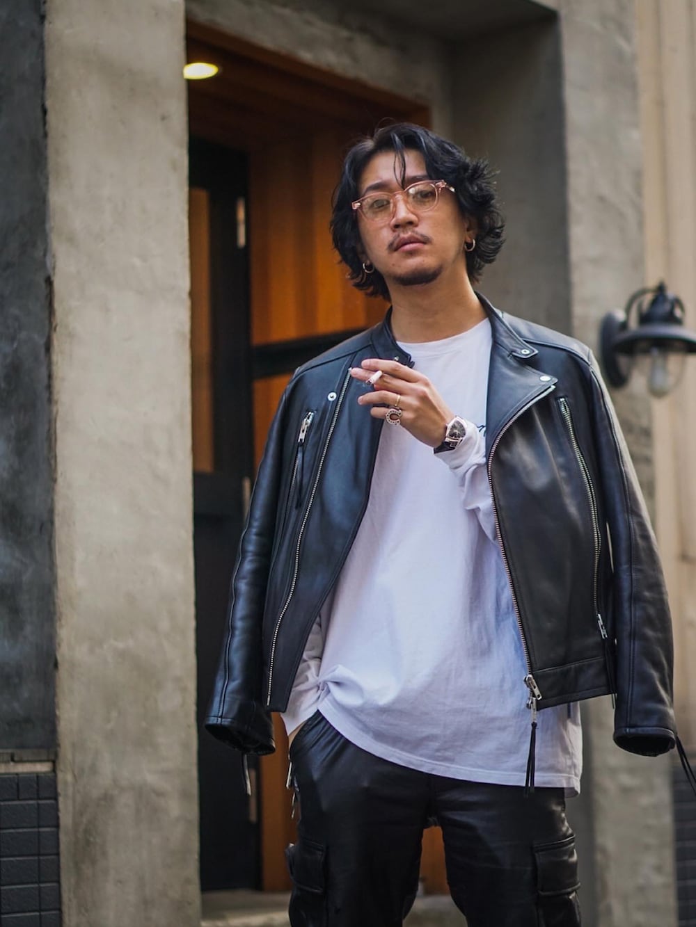 ホワイト系のTシャツ/カットソー、ブラック系のカーゴパンツ、ブラック系のライダースジャケットを着用したメンズの春コーディネートの2枚目の写真