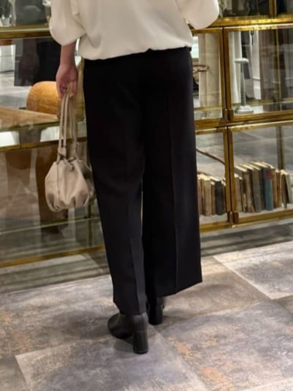 ベージュ系のショルダーバッグ、ホワイト系のシャツ/ブラウス、ブラック系のその他パンツを着用したレディースの冬コーディネートの8枚目の写真