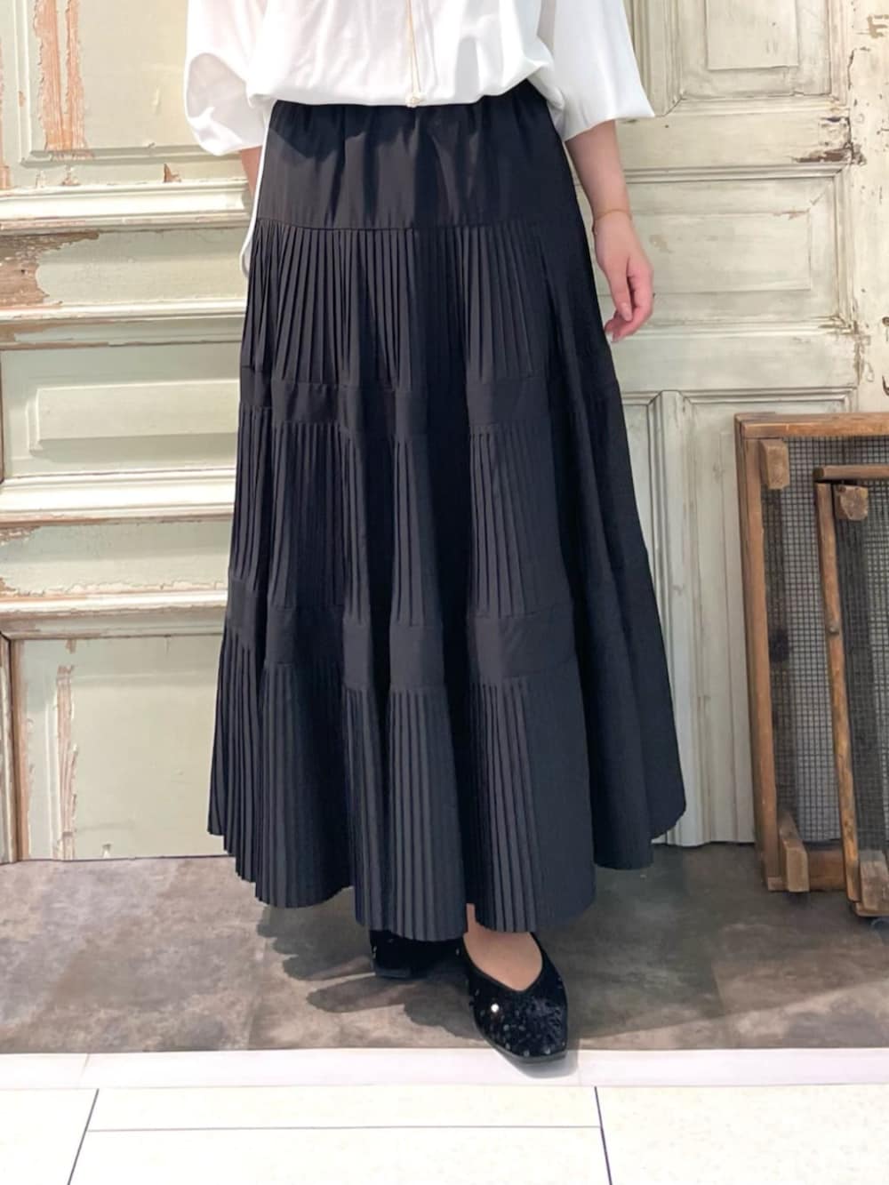 ブラック系のスカート、ホワイト系のシャツ/ブラウスを着用したレディースの春コーディネートの6枚目の写真