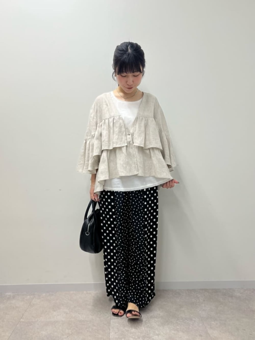 ブラック系のボストンバッグ、ホワイト系のシャツ/ブラウス、ブラック系のその他パンツを着用したレディースの春コーディネートの6枚目の写真