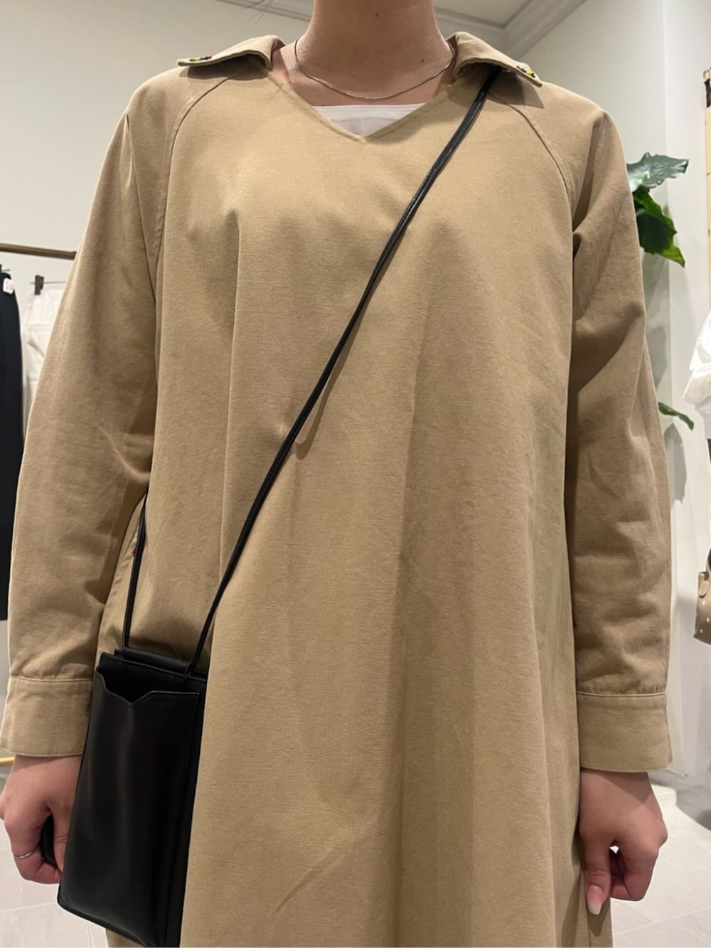 ブラック系のショルダーバッグ、ベージュ系のワンピースを着用したレディースの春コーディネートの7枚目の写真