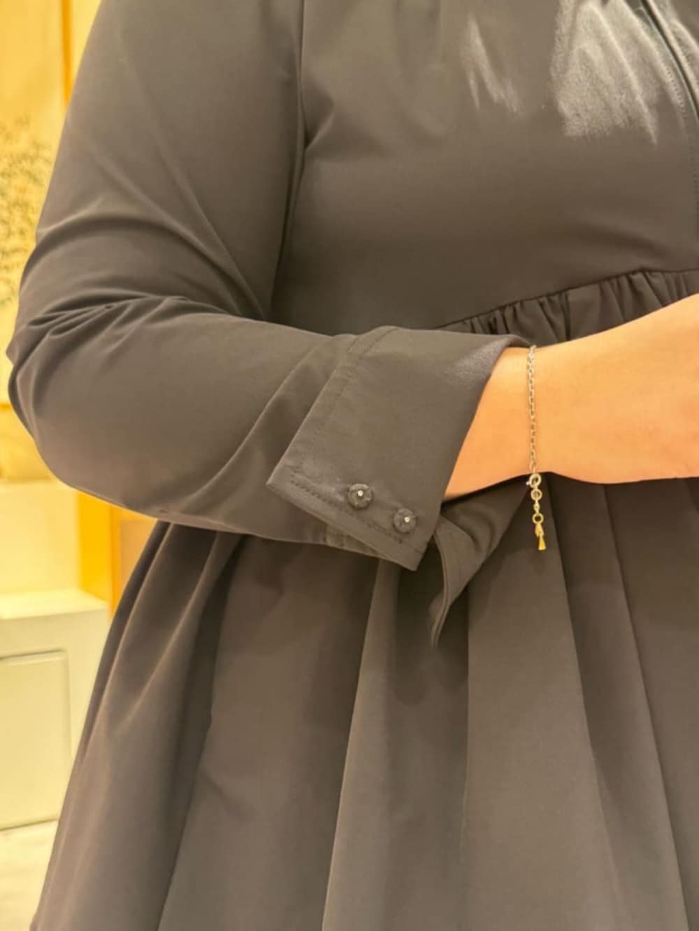 ピンク系のハンドバッグ、ブラック系のブーツ、ブラック系のブルゾンを着用したレディースの冬コーディネートの6枚目の写真