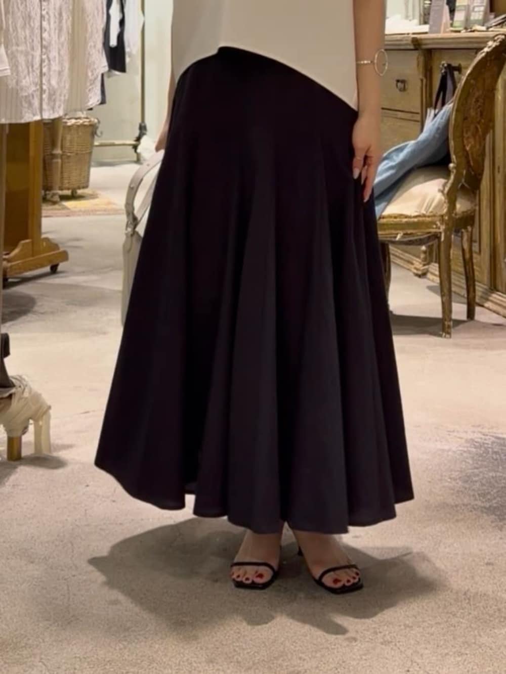 ホワイト系のトートバッグ、ホワイト系のシャツ/ブラウス、ブラック系のスカートを着用したレディースの春コーディネートの4枚目の写真