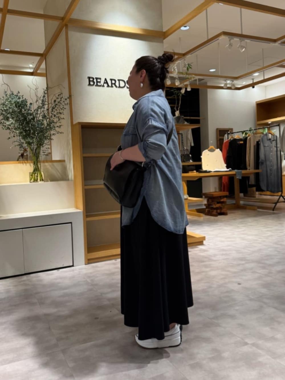 ブルー系のシャツ/ブラウス、ブラック系のショルダーバッグ、ブラック系のワンピースを着用したレディースの春コーディネートの3枚目の写真