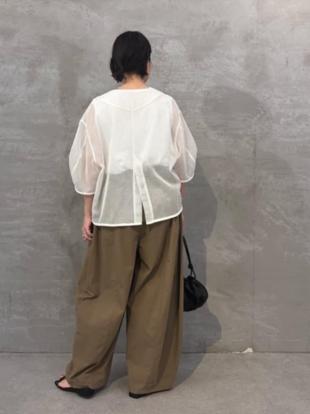 イエロー系のその他パンツ、ホワイト系のシャツ/ブラウス、ブラック系のトートバッグを着用したレディースの春コーディネートの6枚目の写真