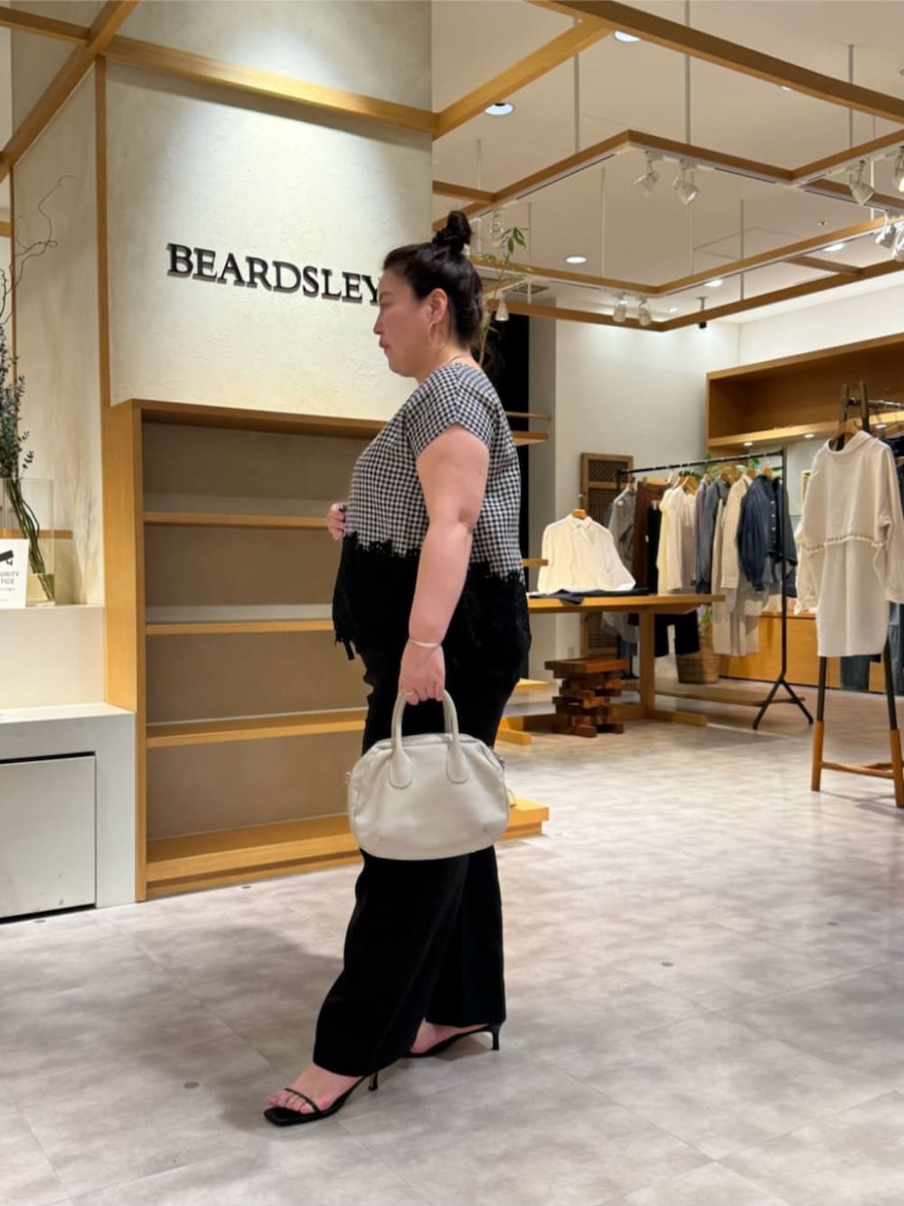 グレー系のボストンバッグ、ブラック系のその他パンツ、ブラック系のシャツ/ブラウスを着用したレディースの春コーディネートの2枚目の写真